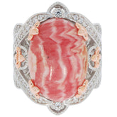 Elegant oval red coral ring in sterling silver with accent stones, perfect for sophisticated style and luxury.